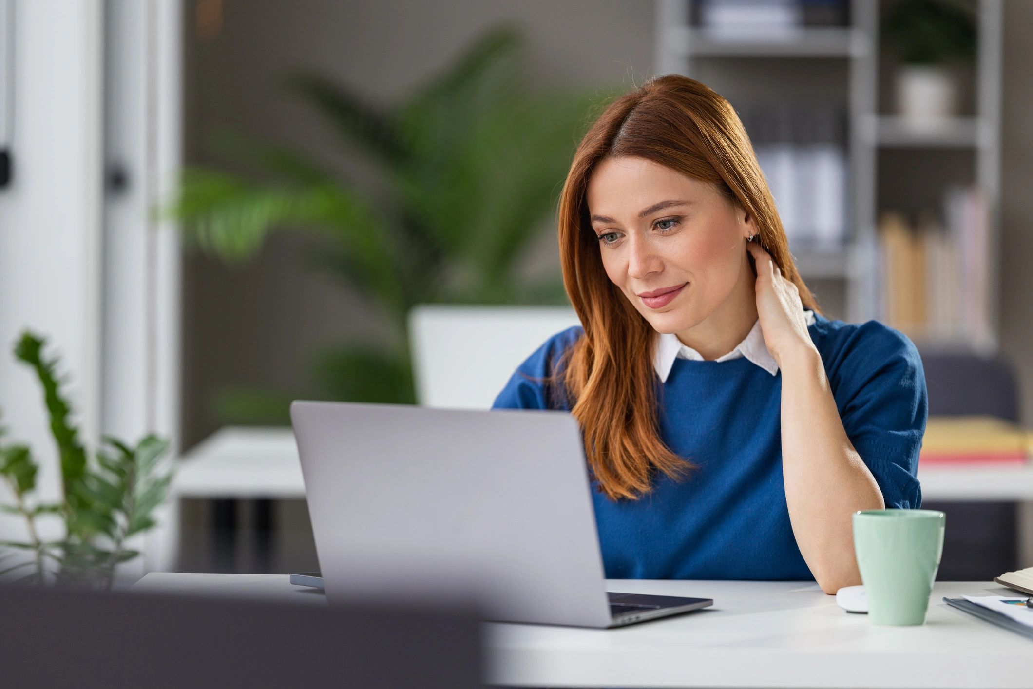 Professional working at a laptop in a bright office